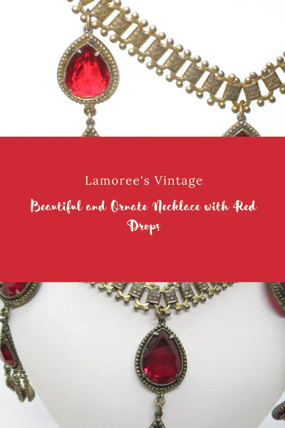 Experience breathtaking beauty with our exclusive Ornate Vintage Drop Necklace. Radiant red teardrop stones set in three long cascading drops, topped with two more tiers of red teardrops, create an eye-catching sparkle that will leave everyone awestruck.