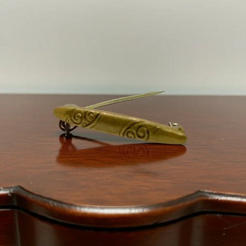  The intricate scroll work and graceful, tapered design add a touch of sophistication to any look. Measuring 1.24" x .18", this piece exudes elegance and is secured with a C closure.