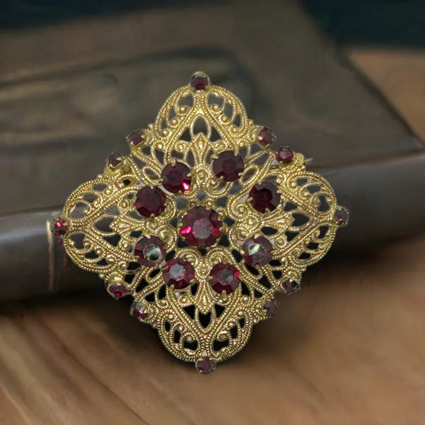Intricate Vintage Gold Tone Brooch with Ruby Red Stones