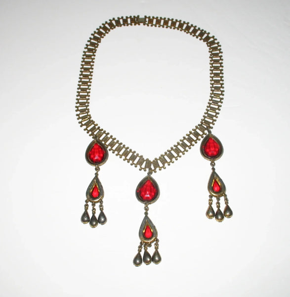 Experience breathtaking beauty with our exclusive Ornate Vintage Drop Necklace. Radiant red teardrop stones set in three long cascading drops, topped with two more tiers of red teardrops, create an eye-catching sparkle that will leave everyone awestruck.