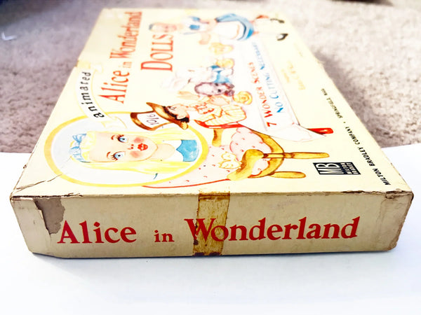 This is a vintage boxed set of "Animated Alice in Wonderland Dolls" paper dolls manufactured by the Milton Bradley Company. The set, number 4109, was designed by Emma C. McKean and includes seven scene cards where the dolls can be inserted into die-cut slits to "animate" the scenes.