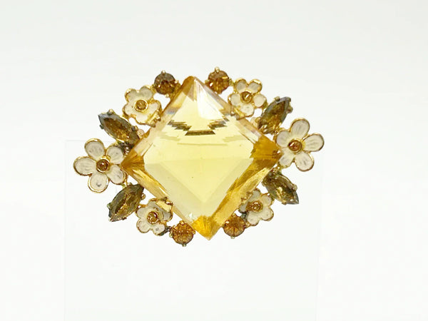 Perfect for vintage jewelry lovers: our Antique Clear Yellow Stone Floral Czech Brooch provides timeless elegance with enameled flowers and a clear center stone. Shop today!