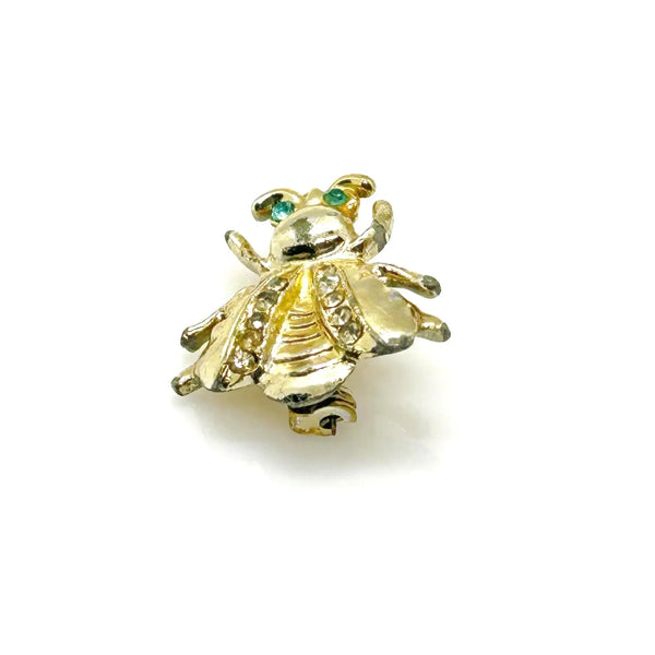 Bring a touch of springtime charm to your ensemble with this exquisite vintage bumble bee brooch. ;Featuring captivating bright aqua green eyes and wings adorned with sparkling, tiny rhinestones, this 1" piece is the ideal accent to add a radiant and nature-inspired flair to any outfit