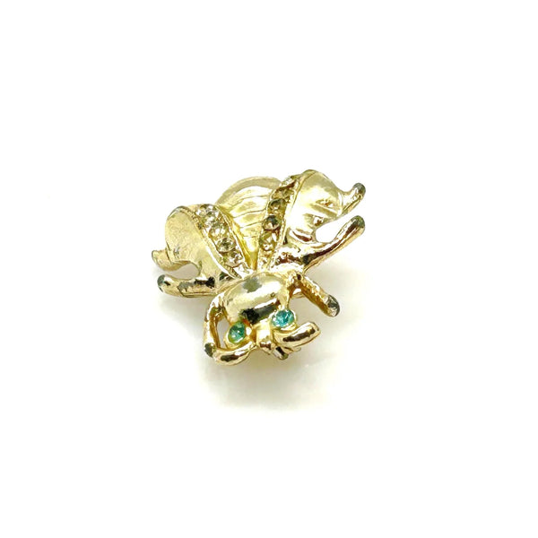 Bring a touch of springtime charm to your ensemble with this exquisite vintage bumble bee brooch. Featuring captivating bright aqua green eyes and wings adorned with sparkling, tiny rhinestones, this 1" piece is the ideal accent to add a radiant and nature-inspired flair to any outfit