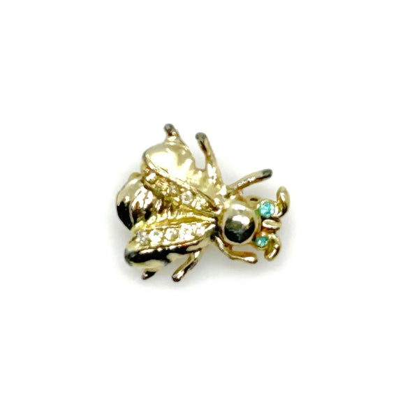 Bring a touch of springtime charm to your ensemble with this exquisite vintage bumble bee brooch. ;Featuring captivating bright aqua green eyes and wings adorned with sparkling, tiny rhinestones, this 1" piece is the ideal accent to add a radiant and nature-inspired flair to any outfit