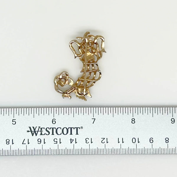Featuring luxuriant ears and brilliant green rhinestone eyes, it captures the essence of your favorite Pekinese or Yorkie. The engraved Avon name adds a touch of sophistication and the 1.75" height makes it a timeless accessory. Whether you're a dog lover or simply appreciate classic pieces, this brooch is a must-have for your collection.