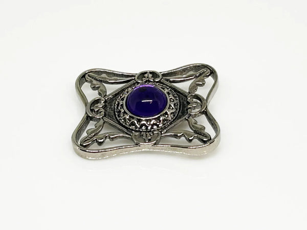 Perfect for vintage Avon enthusiasts: our Bold and Classic Medieval Style Pin with Purple Stone provides timeless elegance and bold sophistication. Shop today!