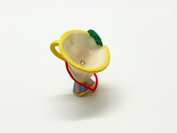 Vintage Schmid Disney Beauty and the Beast ceramic Chip teacup ornament with red hanging cord against a white background