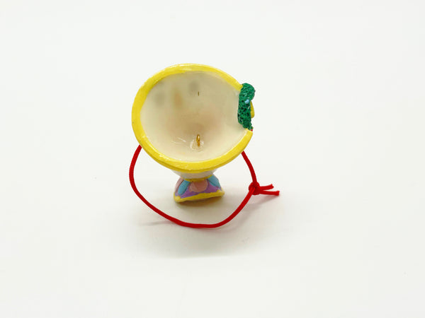 Vintage Schmid Disney Beauty and the Beast ceramic Chip teacup ornament with red hanging cord against a white background