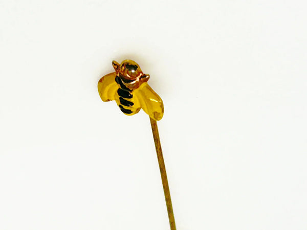 This charming vintage stick pin features a delightful black and gold bee design. The pin measures 1.75” in length, making it a perfect accessory to add a touch of whimsy to any outfit.