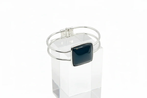 This striking vintage bracelet showcases a bold black square onyx stone set in polished silver. 
