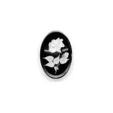 oval cameo brooch depicting a white rose with leaves carved against a dark, polished background. 