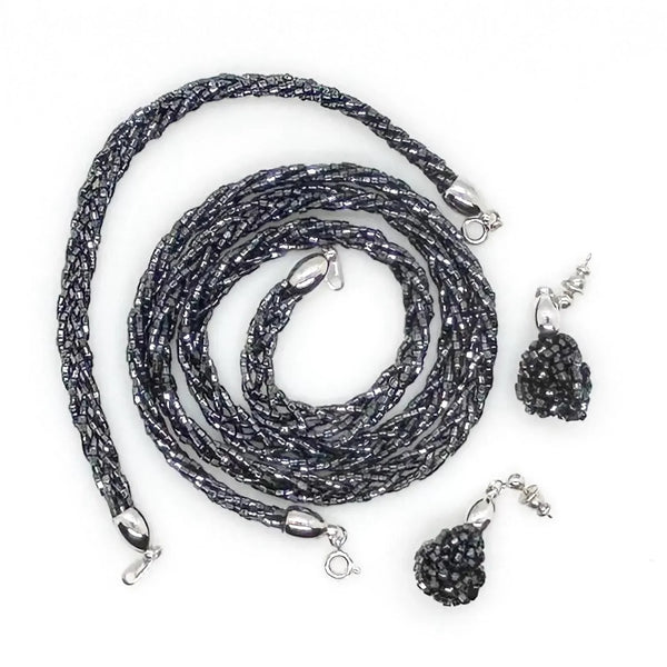 Shop a rare vintage Crown Trifari black braided beaded jewelry set. Features a matching multi-strand glass seed bead torsade necklace, bracelet & dangle earrings.