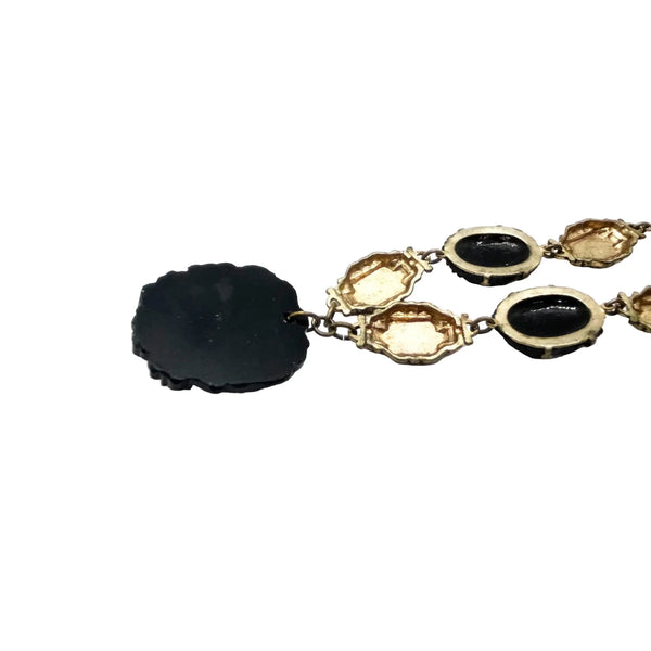 Vintage Art Deco choker necklace featuring gold-tone brass filigree links, two oval black beads, and a large textured black cluster central pendant
