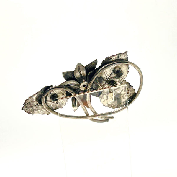 Vintage Silver-Tone Floral Brooch with Blue Rhinestone Center and Textured Leaves