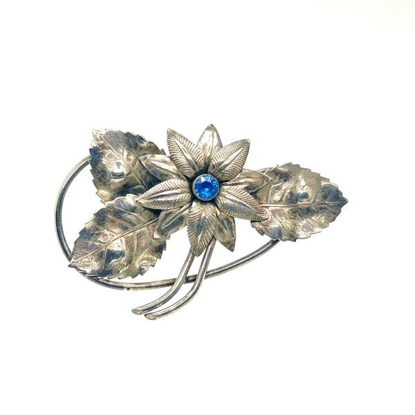 Vintage Silver-Tone Floral Brooch with Blue Rhinestone Center and Textured Leaves