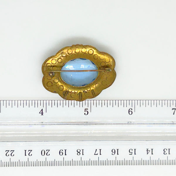 Beautiful Pale Blue Old World Brooch - Features intricate vintage craftsmanship with detailed metal and multiple shimmering blue stones. Shop now!