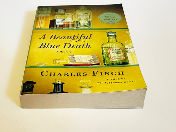 A Beautiful Blue Death by Charles Finch. Published in 2007, it is the debut novel in the Charles Lenox Mysteries series, which features a gentleman amateur sleuth in Victorian London