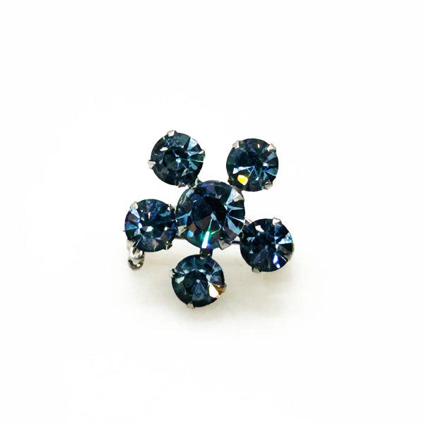 Measuring a delicate .75" across, this piece radiates timeless elegance. The unforgettable, eye-catching blue hue is beautifully complemented by the subtle "Coro" script signature discreetly placed on the back of the piece, adding a touch of authenticity and sophistication to this charming vintage treasure.