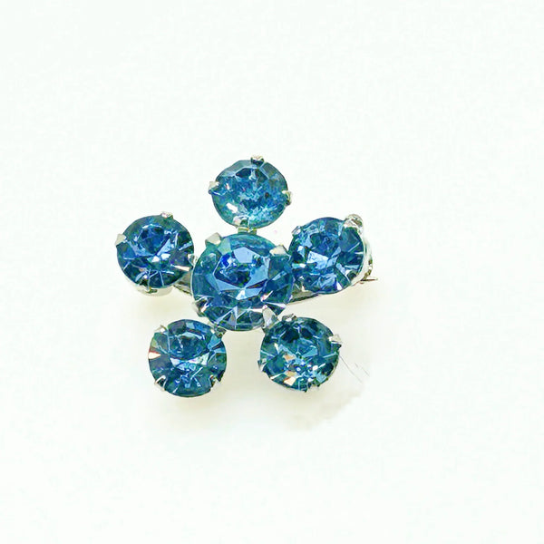 Measuring a delicate .75" across, this piece radiates timeless elegance. The unforgettable, eye-catching blue hue is beautifully complemented by the subtle "Coro" script signature discreetly placed on the back of the piece, adding a touch of authenticity and sophistication to this charming vintage treasure.