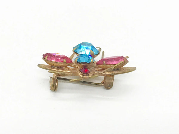 This is probably the prettiest insect you could hope to find—a truly exceptional vintage treasure you won't want to miss. Crafted from lustrous golden metal with meticulous attention to detail, this charming brooch features vibrant round aqua and pink stones that instantly draw the eye. 