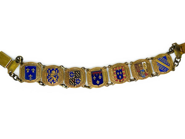 Perfect for vintage jewelry lovers: our Vintage French Souvenir Panel Bracelet provides a stunning display of French heraldic crests. Shop today!
