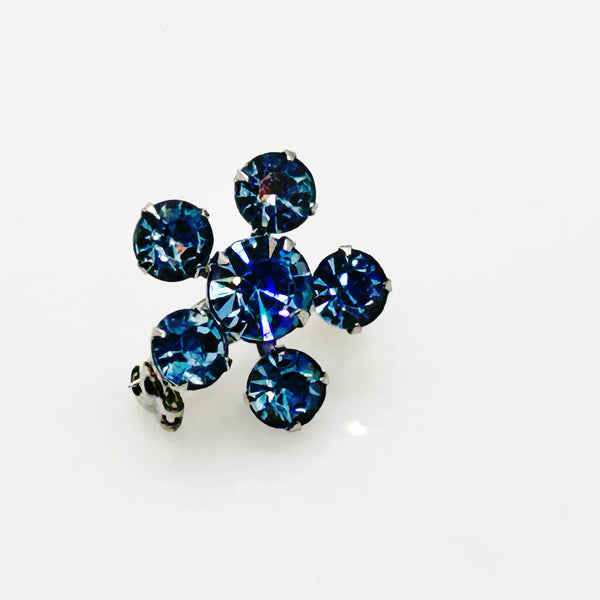 Measuring a delicate .75" across, this piece radiates timeless elegance. The unforgettable, eye-catching blue hue is beautifully complemented by the subtle "Coro" script signature discreetly placed on the back of the piece, adding a touch of authenticity and sophistication to this charming vintage treasure.