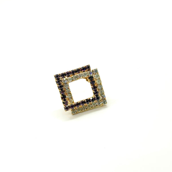 Set of two vintage 3D interlocking square brooches. One features purple and clear prong-set rhinestones on a silver-tone frame. The other features opaque orange and sparkling gold AB crystals on a gold-tone geometric frame