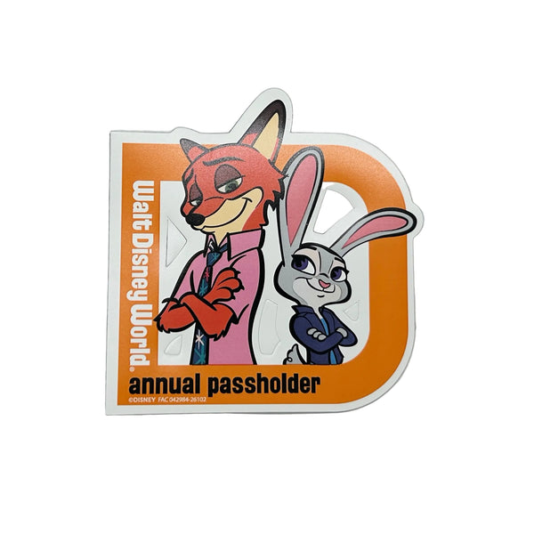 Celebrate your Disney magic with this cheerful 2026 Walt Disney World Annual Passholder Magnet featuring Nick Wilde and Judy Hopps from Zootopia! Shaped like a bold capital 'D', this exclusive winter edition magnet showcases the beloved fox-and-bunny duo in vibrant detail.