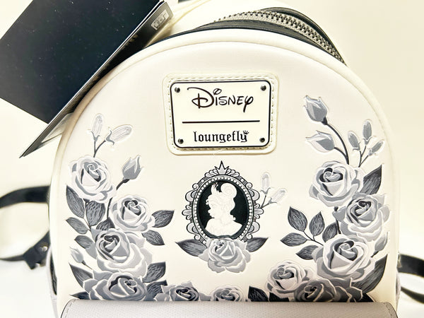 Loungefly Disney Princess Cameo Portraits Mini Backpack—a stunning 2024 release that celebrates timeless elegance! This cream vegan leather beauty showcases exquisite silhouette portraits of your favorite Disney Princesses in sophisticated black and white.