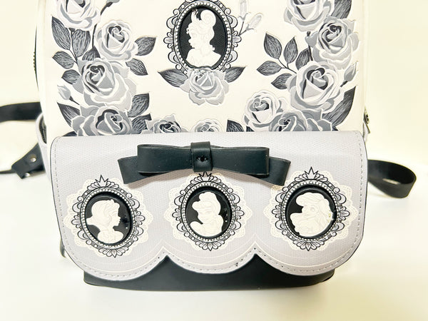 Loungefly Disney Princess Cameo Portraits Mini Backpack—a stunning 2024 release that celebrates timeless elegance! This cream vegan leather beauty showcases exquisite silhouette portraits of your favorite Disney Princesses in sophisticated black and white.