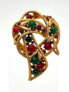 1960s vintage Capri openwork curl brooch featuring textured gold-tone metal set with green faux jade and red carnelian glass cabochons