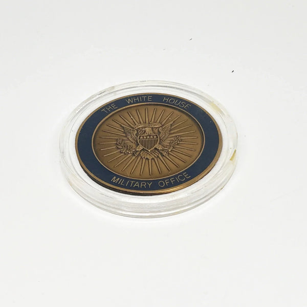 bronze-colored White House Military Office Challenge Coin. It features an image of the White House surrounded by the names of the five military branches: Army, Navy, Air Force, Marine Corps, and Coast Guard.