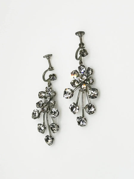 Enhance your elegance with these exquisite vintage drop earrings adorned with varying sizes of round rhinestones, intricately arranged to create a sophisticated design. Watch as they sway gracefully with your every movement, brilliantly reflecting light