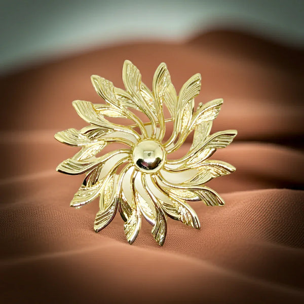 Celebrate timeless elegance with this Sarah Coventry Gold Tone Sunburst Flower Brooch. Featuring a beautifully textured gold-tone design, this vintage piece captures the radiant energy of a blossoming flower or a glowing sunburst.