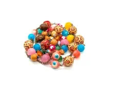 A pile of colorful glass bead necklaces on a plain white background.
