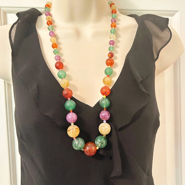 There’s something special about this Graduated Colorful Glass Bead Necklace! It’s stunning to look at and, if your senses are as active as your eyes, your other senses will enjoy it as well.&nbsp; Beads in purple,, jade green and dark red contrast beautifully with one another.