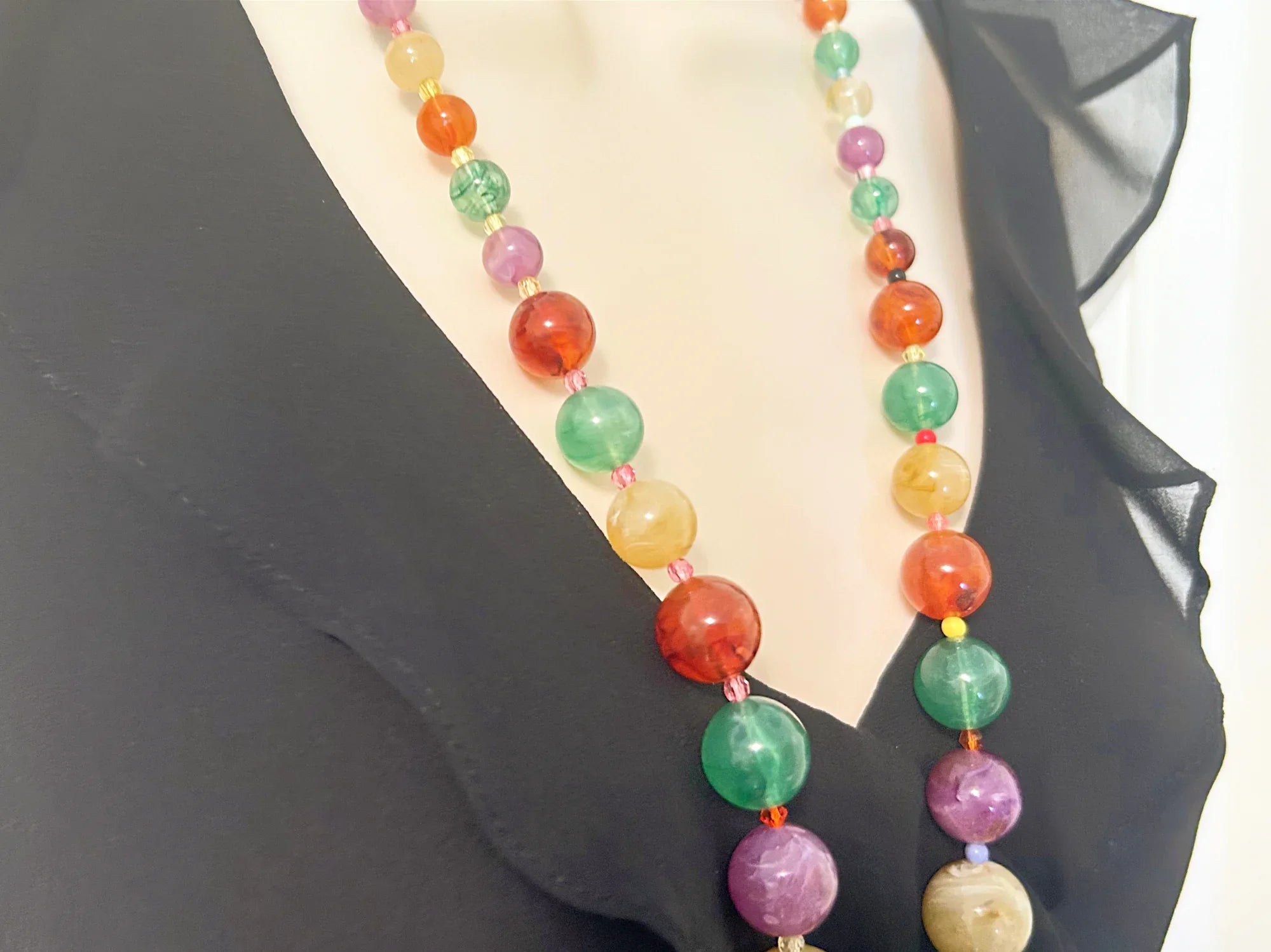There’s something special about this Graduated Colorful Glass Bead Necklace! It’s stunning to look at and, if your senses are as active as your eyes, your other senses will enjoy it as well.&nbsp; Beads in purple,, jade green and dark red contrast beautifully with one another.