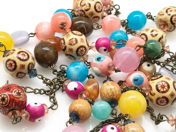 Unleash your wild side with this 60" beaded vintage necklace! Boldly combining vibrant colors, unique shapes, and intricate patterns, it is in excellent condition and ready for any adventure.