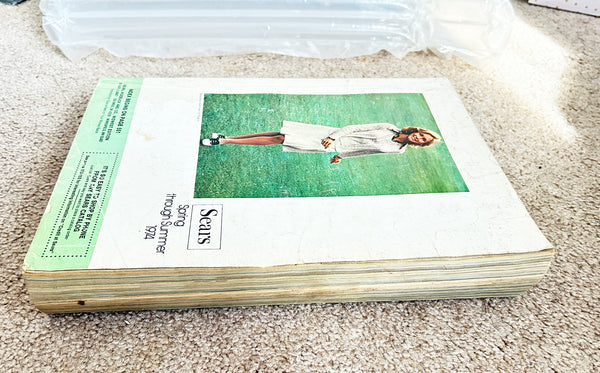 (Detail of condition) - Buckle up for a wild ride through 1974 with this gloriously thick Sears catalog—all 1427 pages of it! 