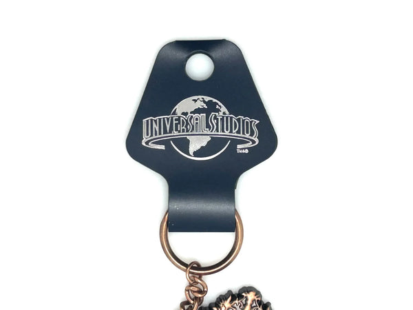 Universal Studios Toothsome Chocolate Emporium steampunk skeleton key metal keychain with exposed clockwork gears on a clean white backdrop