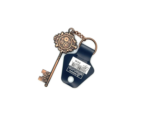 Universal Studios Toothsome Chocolate Emporium steampunk skeleton key metal keychain with exposed clockwork gears on a clean white backdrop
