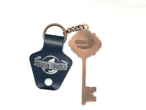 Universal Studios Toothsome Chocolate Emporium steampunk skeleton key metal keychain with exposed clockwork gears on a clean white backdrop