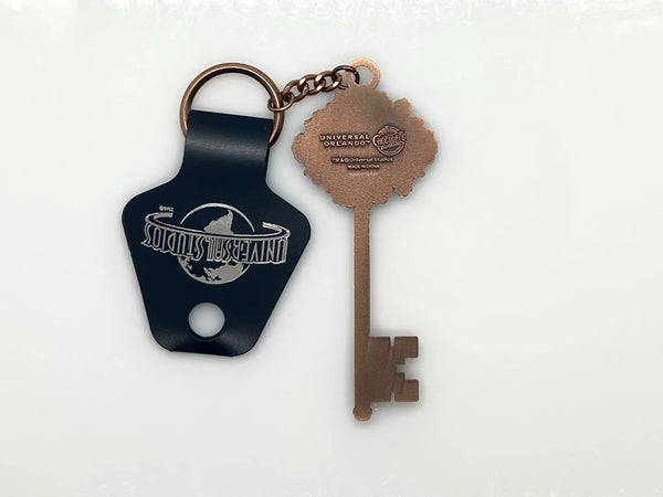 Universal Studios Toothsome Chocolate Emporium steampunk skeleton key metal keychain with exposed clockwork gears on a clean white backdrop