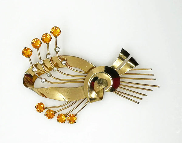 This is a massive Coro Sterling Floral Spray &amp; Ribbon Design brooch. Get mesmerized by the splendor of this vintage brooch, measuring just under 4 inches. The bouquet, intricately designed with a bow, boasts of four gold-toned lines adorned with round, citrine-orange stones of varying sizes.