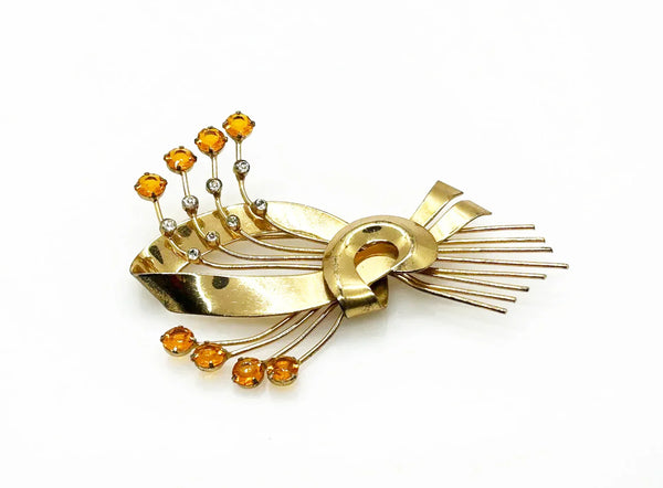 This is a massive Coro Sterling Floral Spray &amp; Ribbon Design brooch. Get mesmerized by the splendor of this vintage brooch, measuring just under 4 inches. The bouquet, intricately designed with a bow, boasts of four gold-toned lines adorned with round, citrine-orange stones of varying sizes.