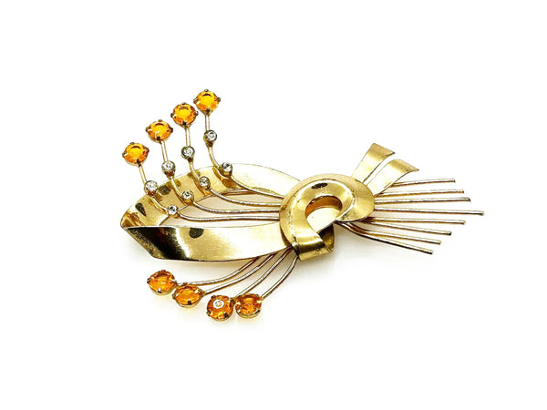 This is a massive Coro Sterling Floral Spray &amp; Ribbon Design brooch. Get mesmerized by the splendor of this vintage brooch, measuring just under 4 inches. The bouquet, intricately designed with a bow, boasts of four gold-toned lines adorned with round, citrine-orange stones of varying sizes.