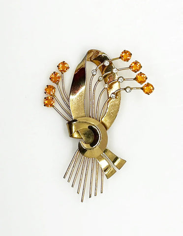 This is a massive Coro Sterling Floral Spray &amp; Ribbon Design brooch. Get mesmerized by the splendor of this vintage brooch, measuring just under 4 inches. The bouquet, intricately designed with a bow, boasts of four gold-toned lines adorned with round, citrine-orange stones.