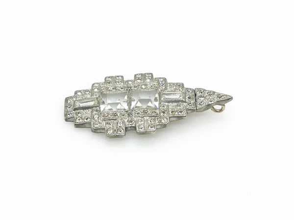 You'll draw attention and compliments with this striking art deco pendant. Its elongated diamond rectangle shape is adorned with dazzling crystals and two sparkling square stones at the center. 