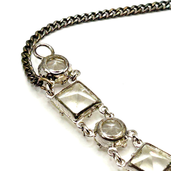 Vintage Art Deco style clear rhinestone geometric bracelet with alternating round and square-cut crystal links in a silver-tone setting on a plain white background